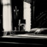 a mostly shadowed black and white picture of a large four poster bed in a dark gothic room