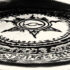 A black and white image of a demonic circle burnt into a rug.