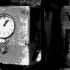 An old-fashion time clock with punch cards next to it, and a sign reading "You Must Punch In."