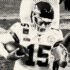 stylized black and white image of three football players, one of whom is holding the ball.